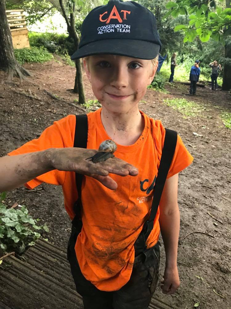 Muddy child holds snail