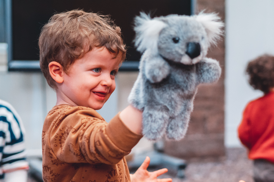 Child with koala puppet 