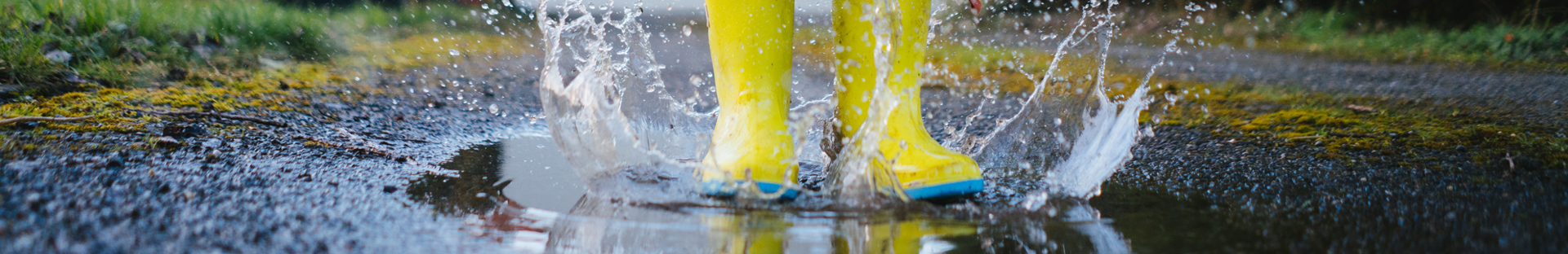 wellies jumping in a puddle