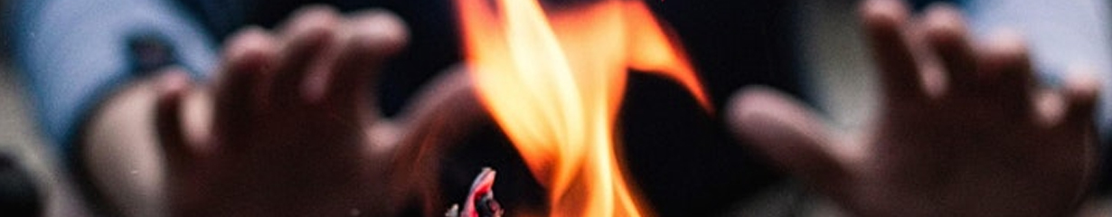 holding up hands near the fire