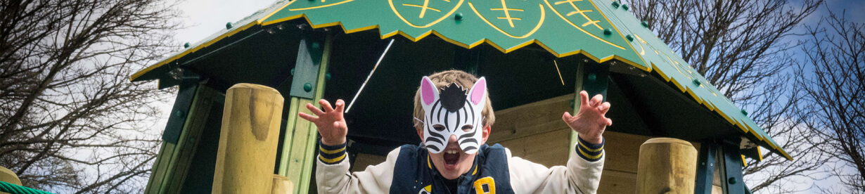 A child wearing a mask playing on a park